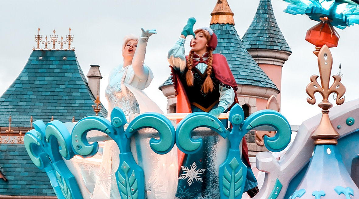 Disney’s Elsa and Anna from Frozen on a carnival float in a Disneyland Paris parade